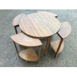 A circular mahogany coffee table holding four subsidiary quarter tables with undertier stretchers,