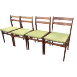 A set of four Meredew mid-century teak dining chairs with twin barbacks above padded upholstered