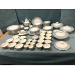 A Royal Doulton dinner and tea service decorated in the gray Reflection pattern with plates,