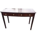A bowfronted Edwardian mahogany serving table with ribbed edge to top above a pair of cockbeaded