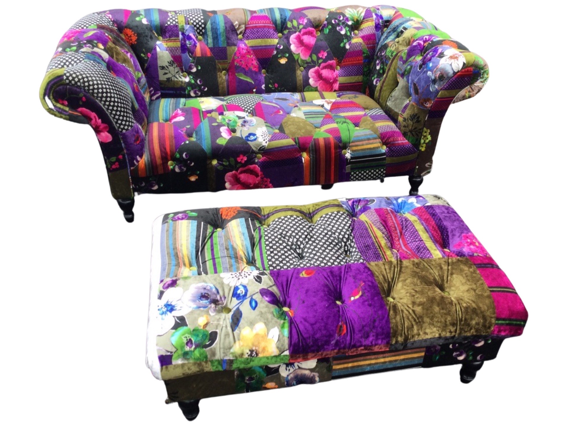 A wacky colourfully upholstered sofa and pouffe, with button upholstery to patchwork velour,