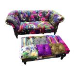 A wacky colourfully upholstered sofa and pouffe, with button upholstery to patchwork velour,