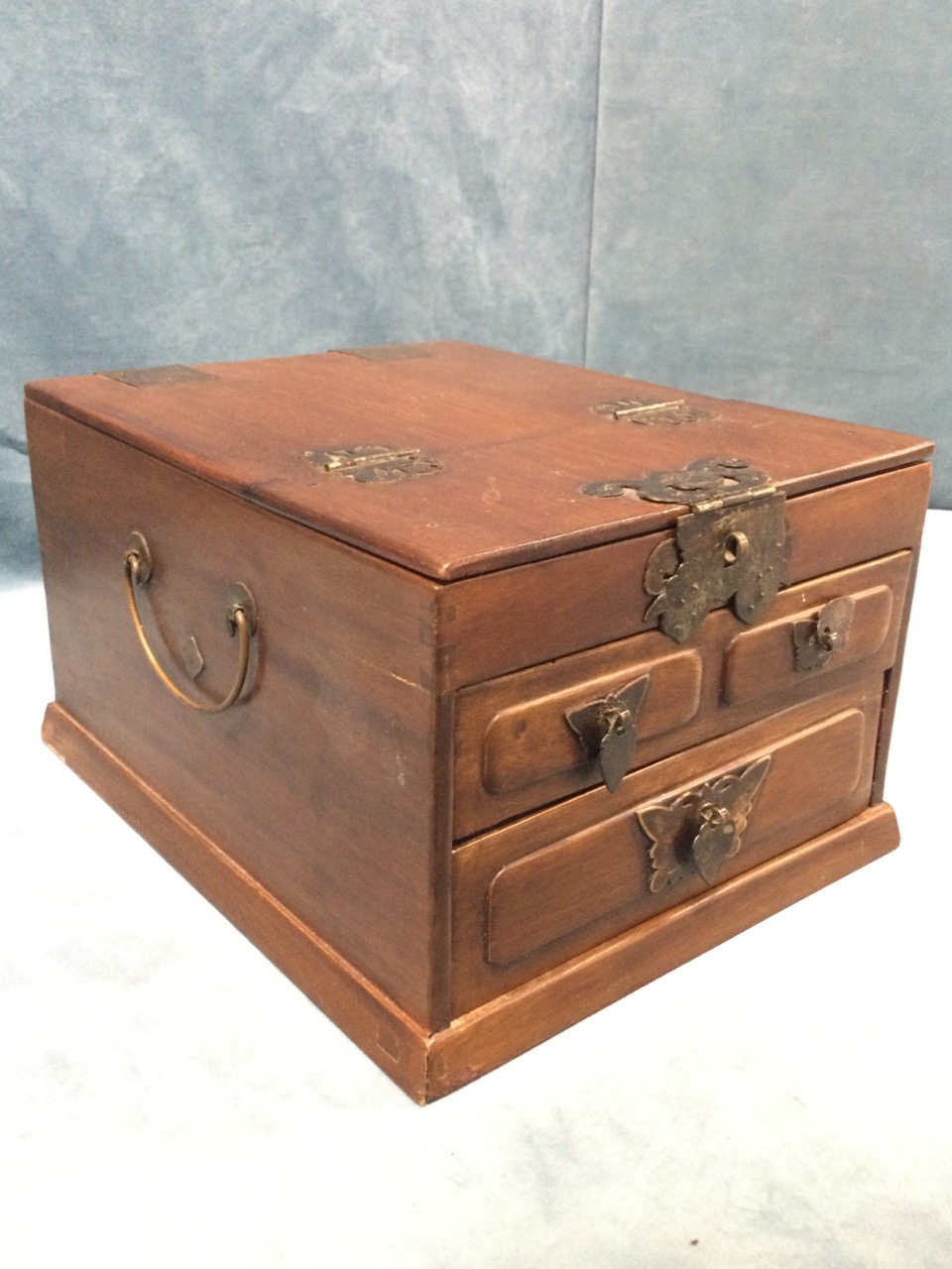 A Japanese dressing box with pierced decorative mounts, the hinged lid revealing a framed mirror