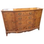 A bowfronted yew sideboard, the crossbanded top, drawers and cupboards all inlaid with boxwood