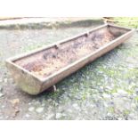 A rectangular crescent shaped cast iron farm trough. (35in)