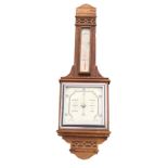 A 1930s oak barometer with carved blind fretwork decorated bands to case, with square silvered