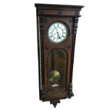 A large Victorian walnut cased Vienna wallclock, with ebonised mouldings and applied decorative