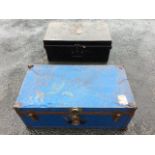 An old tin trunk with iron mounts and swing handles; and a blue painted tin trunk with lined