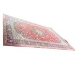 A large Indian carpet woven with ink blue spandrels and conforming central floral medallion on