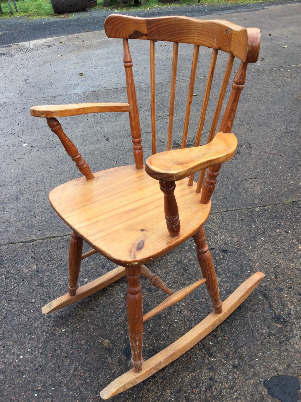 A pine rocking chair with spindle back and tapering platform arms, the solid seat raised on turned - Image 3 of 3