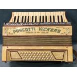 An Italian piano accordion in ivory coloured marbleised case with three octave keyboard, leather