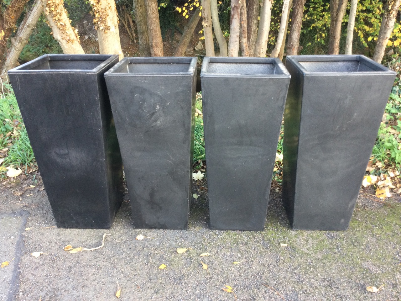 A set of four large resin moulded charcoal coloured square tapering garden tubs. (15.75in x 15.