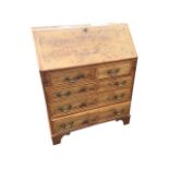 A Georgian style yew bureau with crossbanded fallfront and drawers inlaid with boxwood stringing,