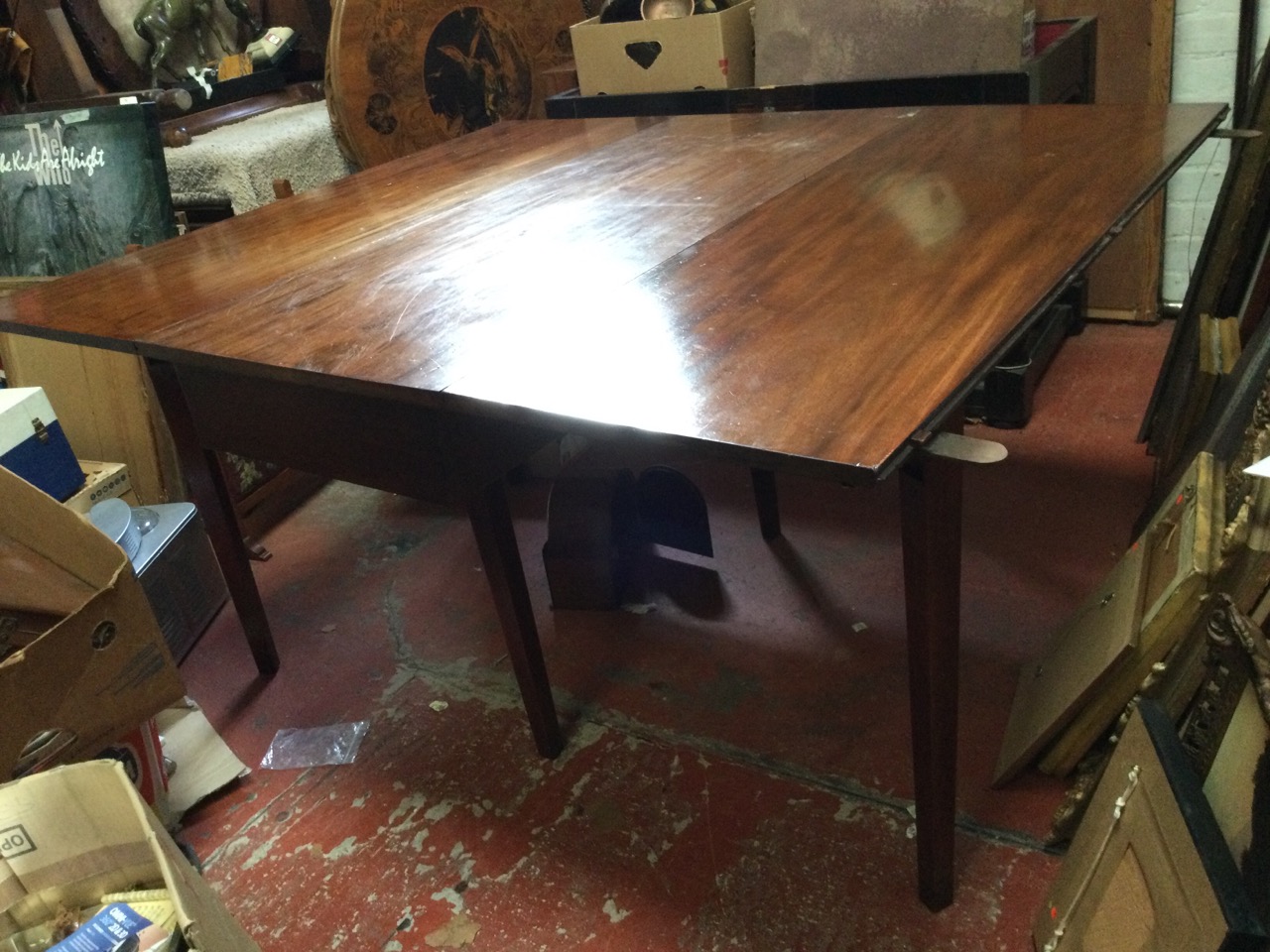 A nineteenth century mahogany dining table with drop-leaves, the rectangular top on six square - Image 2 of 3