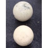 A graduated pair of painted composition stone balls - 12in & 9in dia. (2)
