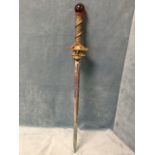 A wizard sword, the pierced tapering steel blade with embossed snakeskin style strap-bound hilt, the