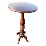 An oval Victorian mahogany jardiniere stand supported on a turned column with quadripartite shaped