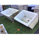 Two glazed butlers sinks, the angled fronts with cushion moulded rims. (27.25in & 23.25in) (2)