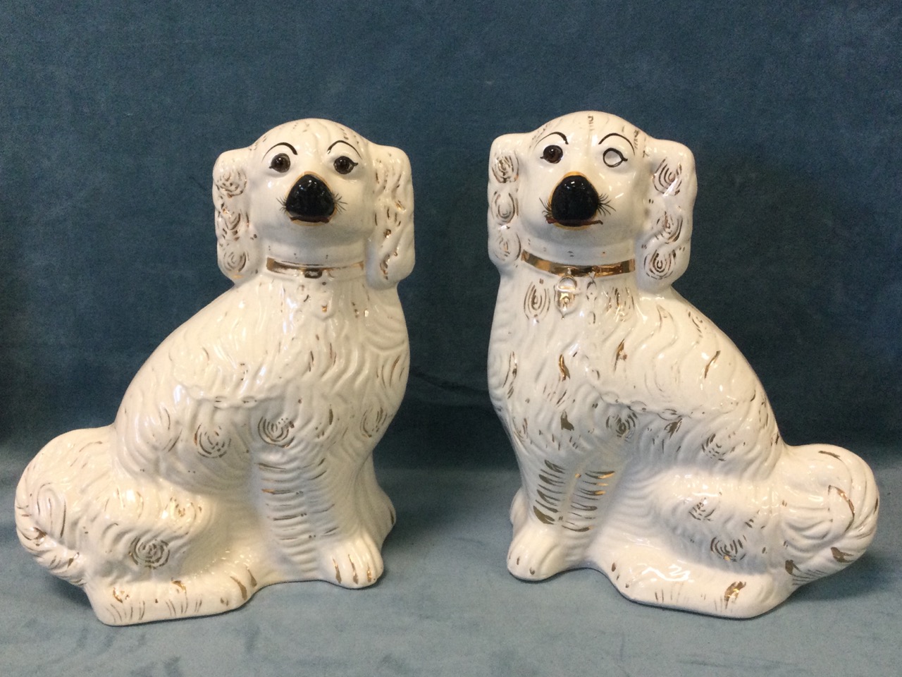 A pair of large late Victorian Staffordshire wally dogs with gilt decoration and collars, having