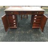 A mahogany pedestal desk, the rectangular top set with leather skiver above three frieze drawers,