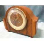 A walnut cased 50s mantleclock with Smiths movement striking on gong, the circular dial under convex