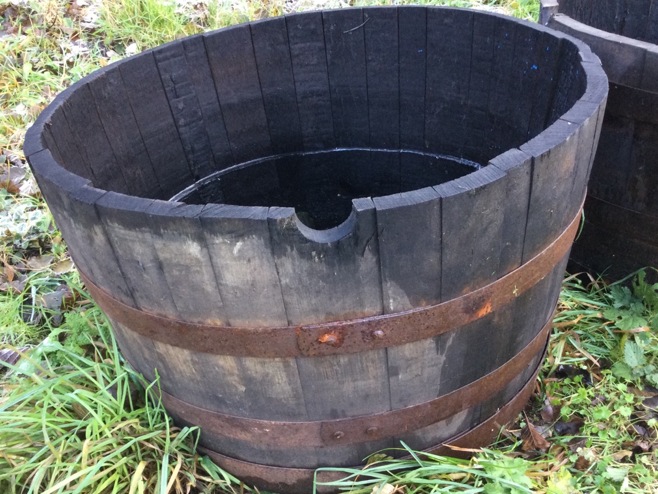 A graduated pair of oak garden barrel tubs, the staves bound by riveted metal strap bands. (24in & - Image 2 of 3