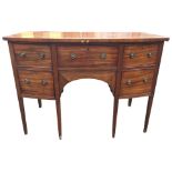 A bowfronted Georgian mahogany sideboard with central frieze drawer above an arched apron drawer,