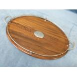 An oval Edwardian oak drinks tray with central vacant silver plated panel, and gallery rail on