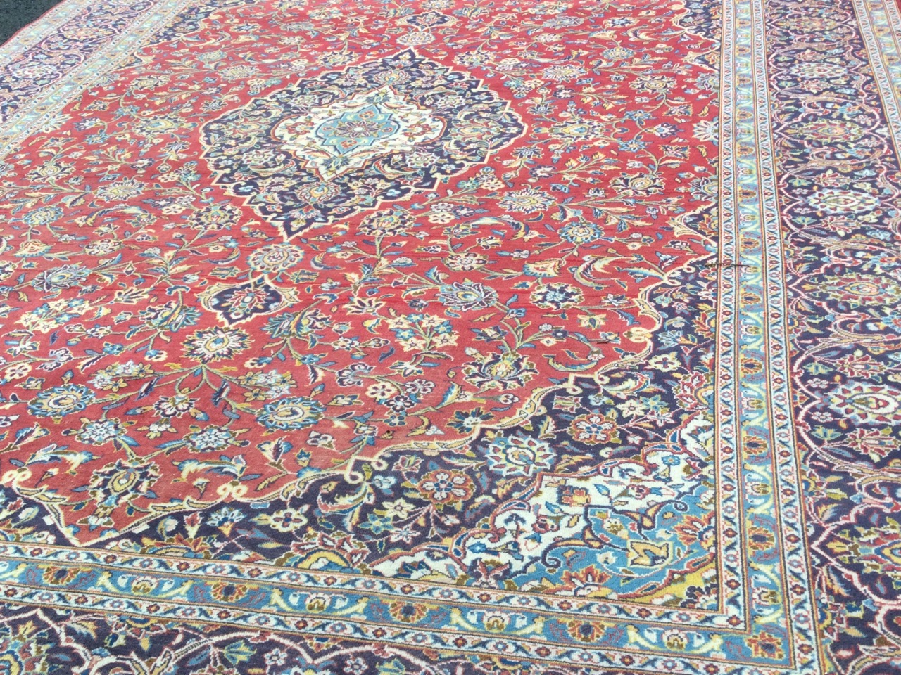 A large Indian carpet woven with ink blue spandrels and conforming central floral medallion on - Image 2 of 3