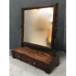 A nineteenth century mahogany dressing table mirror decorated with ebonised mouldings, the