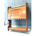 A late Victorian mahogany hanging cupboard with shelf above a chamfered panelled door, with open