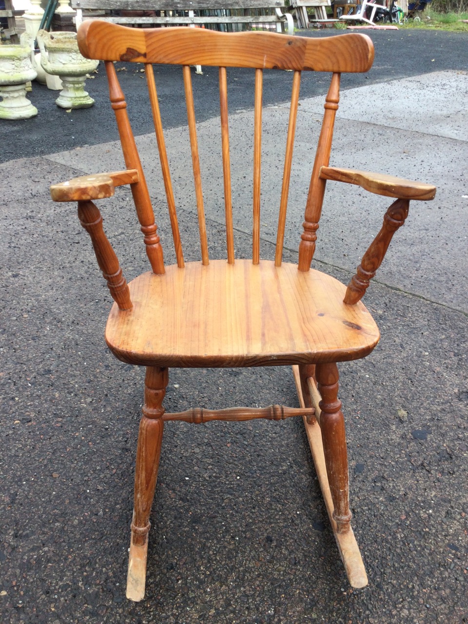 A pine rocking chair with spindle back and tapering platform arms, the solid seat raised on turned - Image 2 of 3