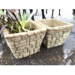 A pair of square tapering composition stone garden pots, moulded as stonework. (10in x 10in x 7.
