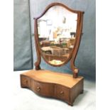 A nineteenth century mahogany dressing table mirror with shield shaped plate on curved tapering