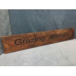 A rectangular oak sign with routed lettering reading Grazing Animals. (45.25in x 8in)