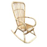 A cane rocking chair with tapering spade back and rounded arms above a bentwood frame on shaped