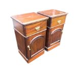 A pair of mahogany bedside cabinets with rectangular rounded moulded tops above frieze drawers and