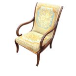 A Victorian style mahogany easy chair by Strongbow, with ribbed scrolled arms and sabre legs, having