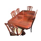 A reproduction mahogany dining suite, the table with crossbanded cut-corner parquetry top above a