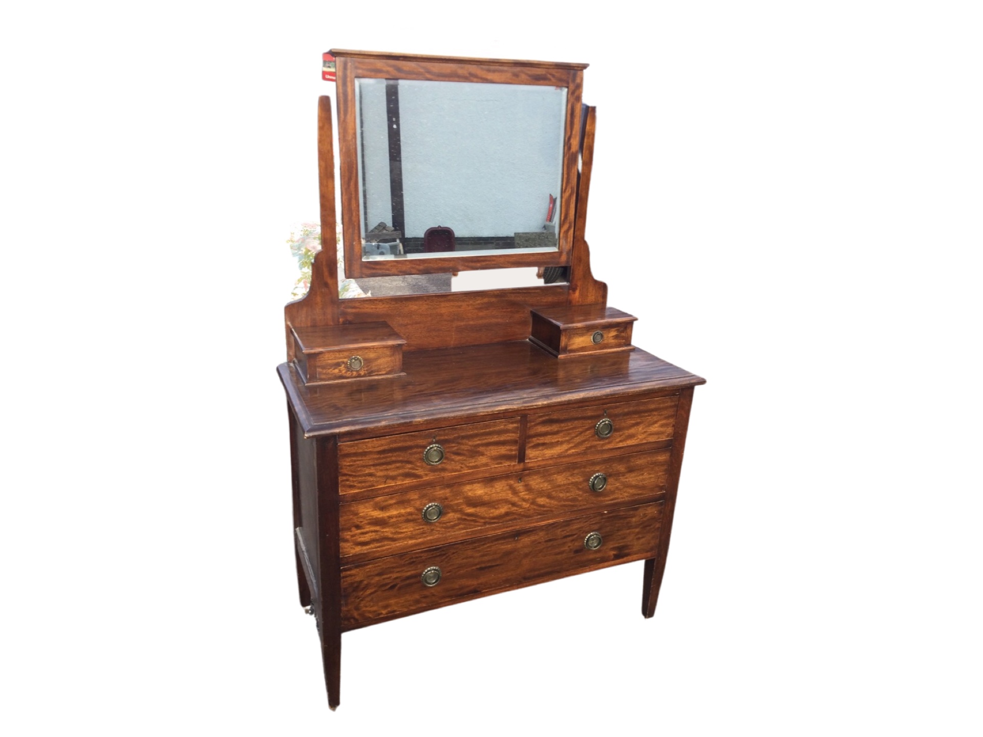 A mahogany dressing table with bevelled mirror in rectangular frame above two small drawers, the