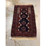 Eastern rug with geometric decoration on red ground, 143cm x 94cm