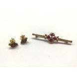 Gold bar brooch set with pink stones and a central diamond, together with pair gem set stud earrings