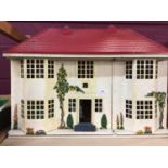 Vintage metal dolls house with sliding frontage and plastic furnishings, plus miniature tea ware and