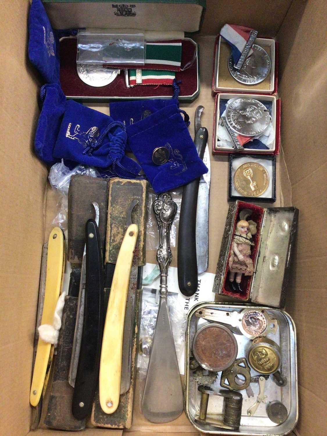 Two trench art lighters, cut throat razors, medals, Victorian miniature china doll and sundries