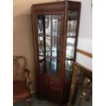 Oriental hardwood two height corner cabinet with bevelled glazed door above enclosing glass shelves,