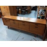 Mid 20th century White & Newton Ltd long teak sideboard with four drawers and cupboards below enclos