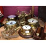 Selection of nautical brass ware including clocks, barometers, port hole mirror and adjustable scope