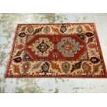 Large rug with geometric decoration on red, blue and beige ground, 201cm x 143cm