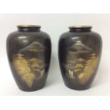 Pair of Japanese bronze and metal applied vases with landscape decoration.