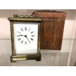 Brass carriage clock in leather travelling case